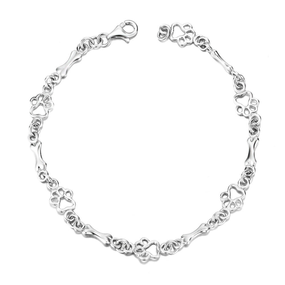 Bracelet with dog paw and bone pendants in silver