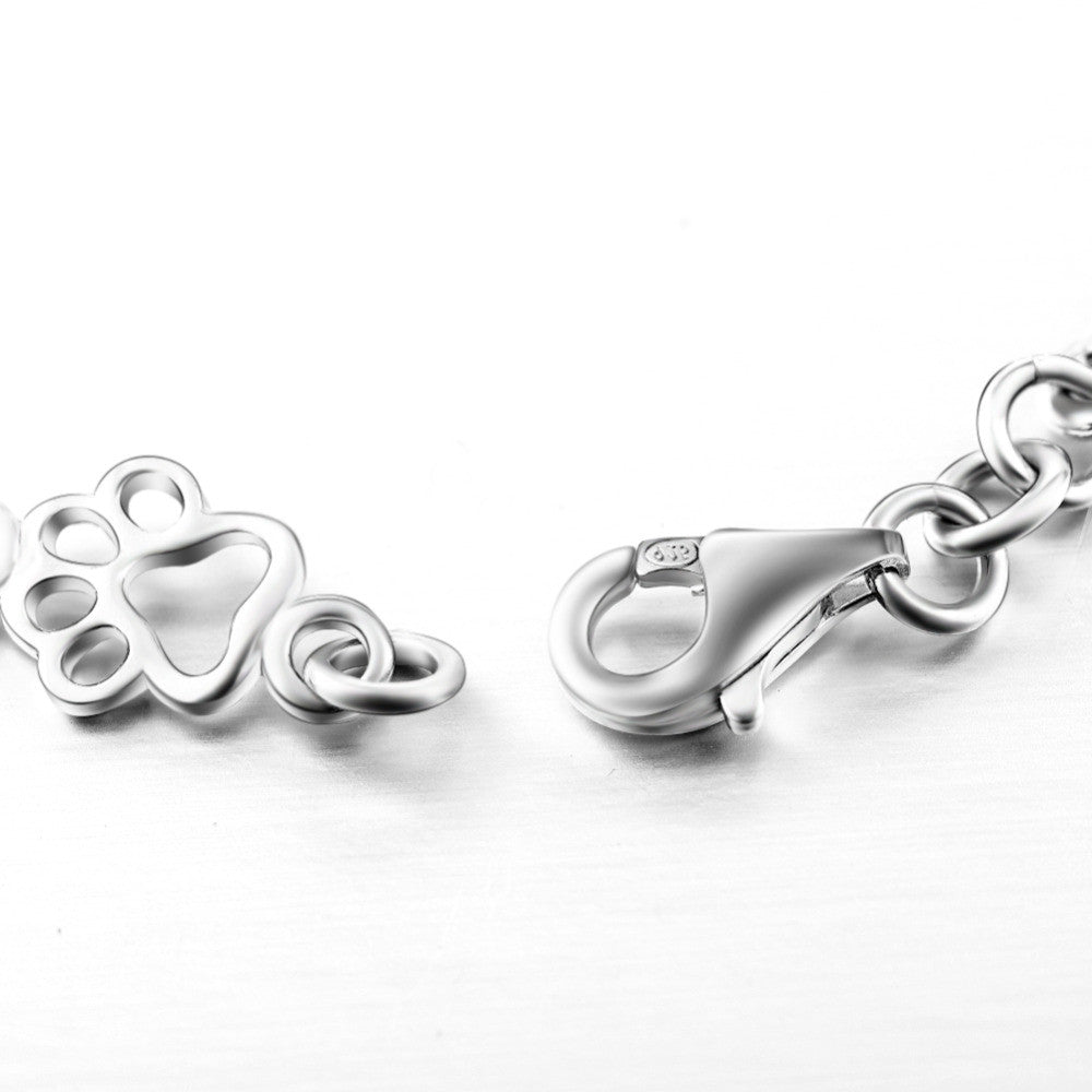 Bracelet with dog paw and bone pendants in silver