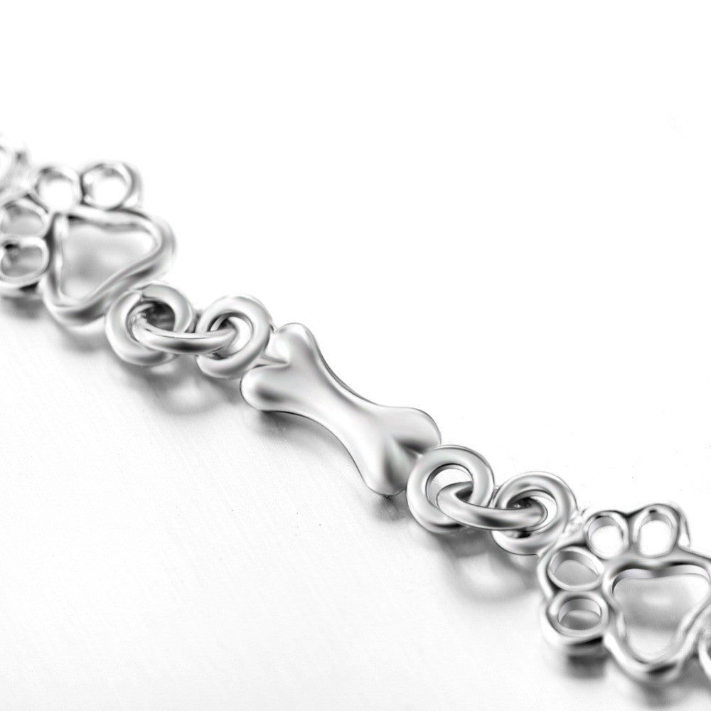 Bracelet with dog paw and bone pendants in silver