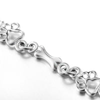 Bracelet with dog paw and bone pendants in silver