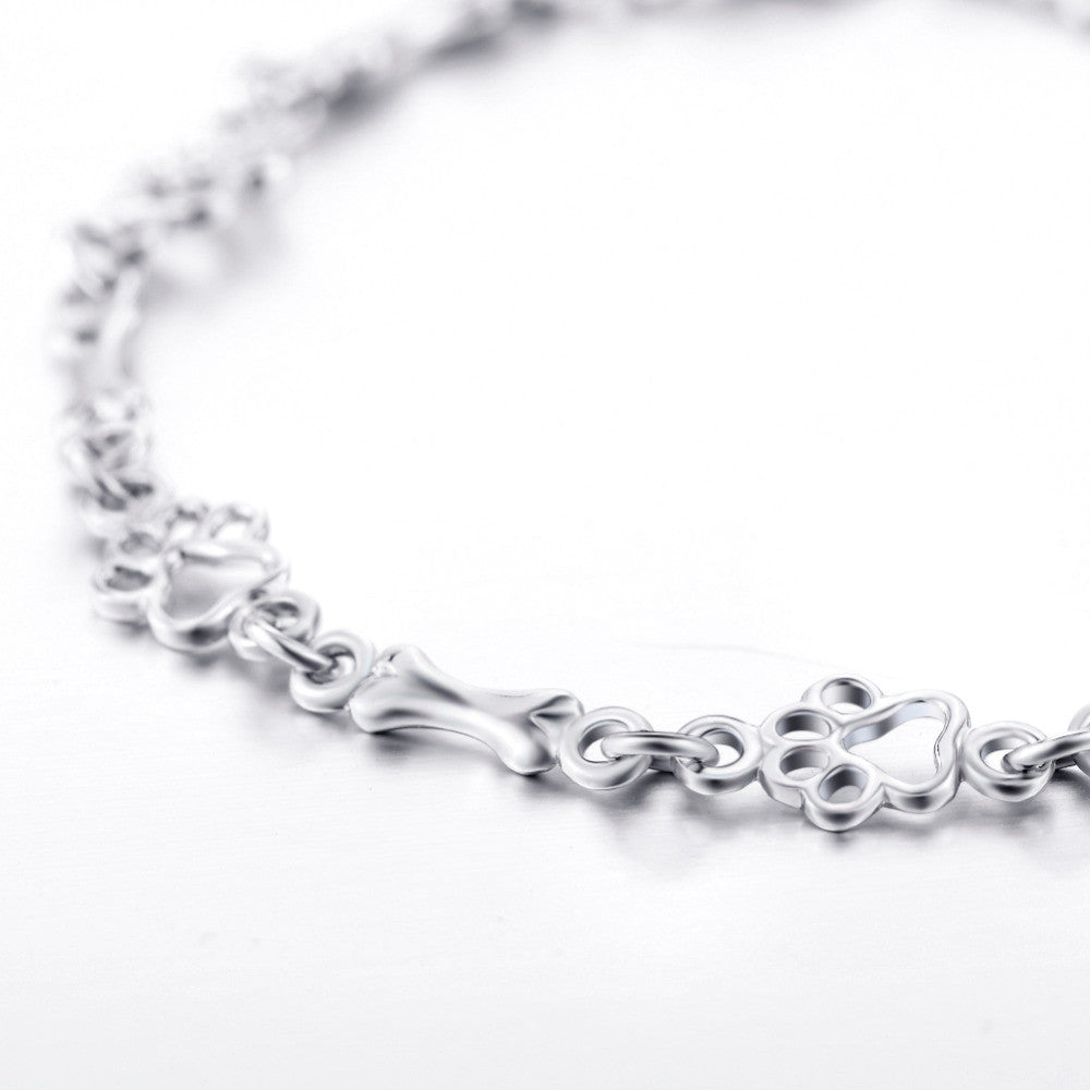 Bracelet with dog paw and bone pendants in silver