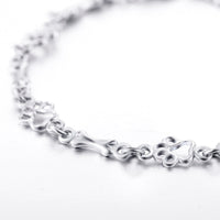 Bracelet with dog paw and bone pendants in silver